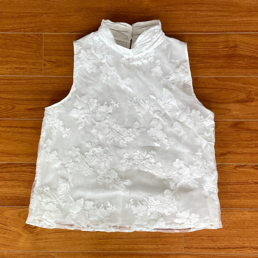Sleeveless high neck white top